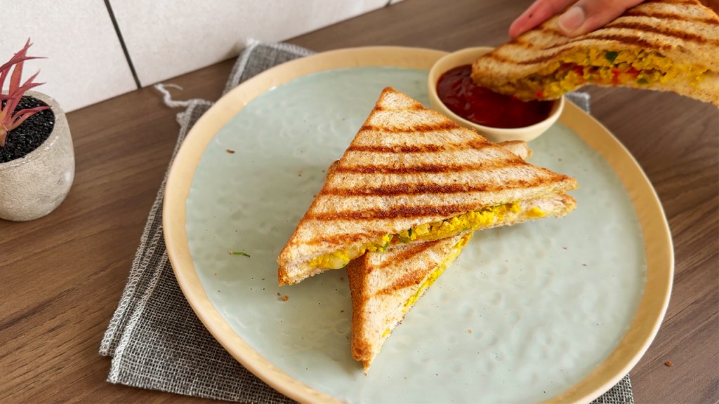 egg masala sandwich dipped into a ketchup sauce