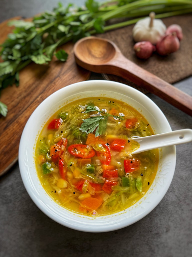 clear vegetable soup in a serving bowl