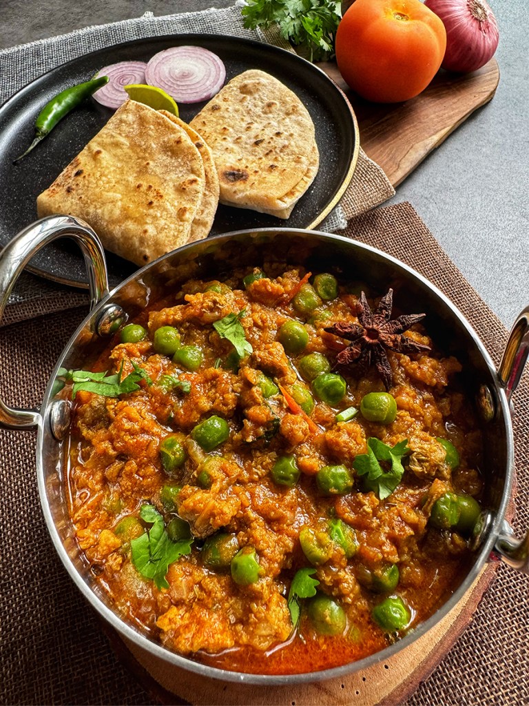 mutton keema in a serving bowl and some chapatis at the side